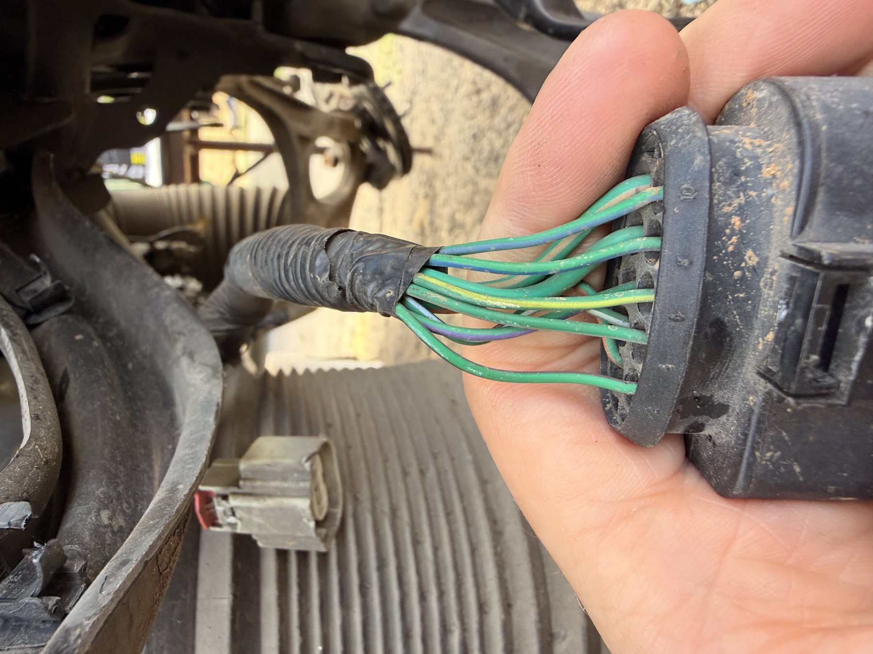 The differential-side connector with its bundle of dark green wires, tracers barely distinguishable