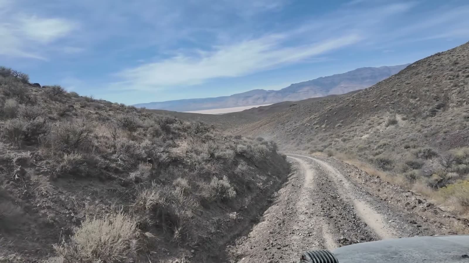 The two-track dropping toward the Alvord, with Steens Mountain beyond