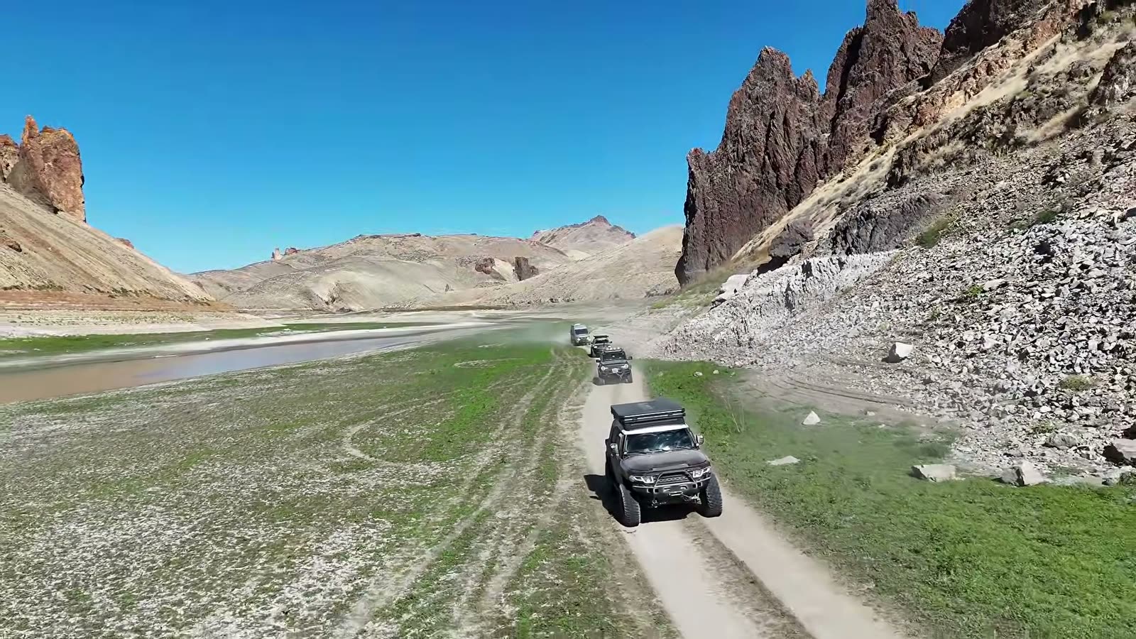 Driving the green, normally flooded reservoir bed beneath the spires