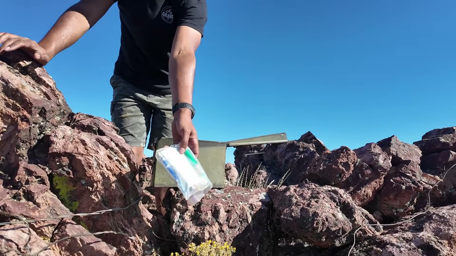 Opening the ammo-can cache in the rocks