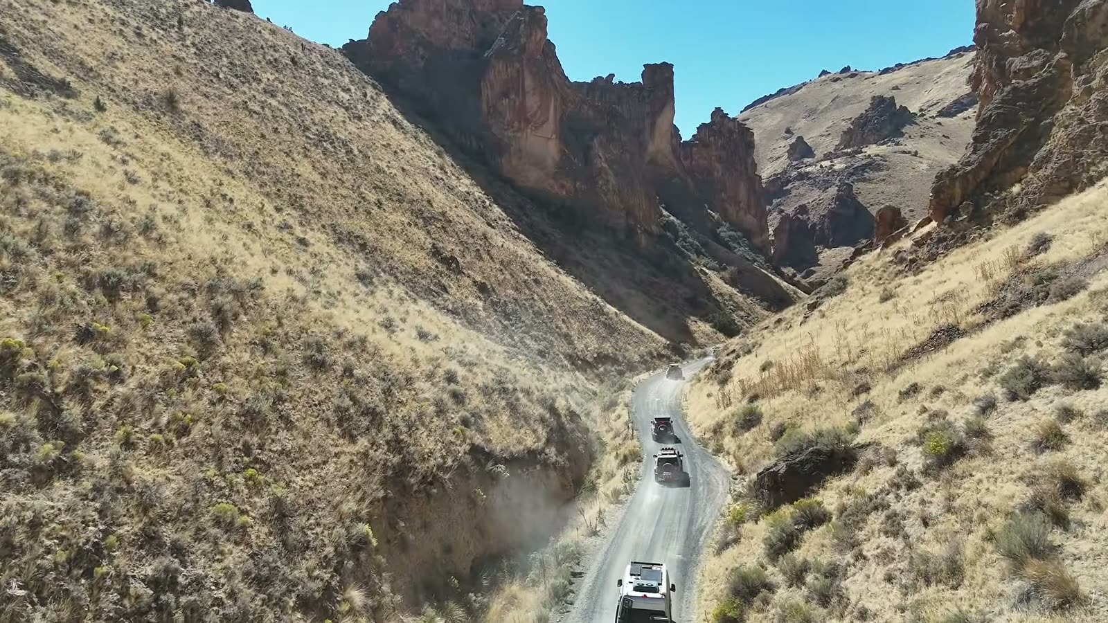 The convoy climbing out between the canyon walls