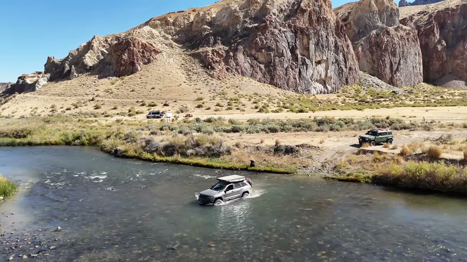 A Grand Cherokee crossing the river beneath the canyon walls